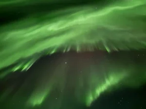レイキャビック近郊で見られるアイスランドの夜空に広がる緑のオーロラ
